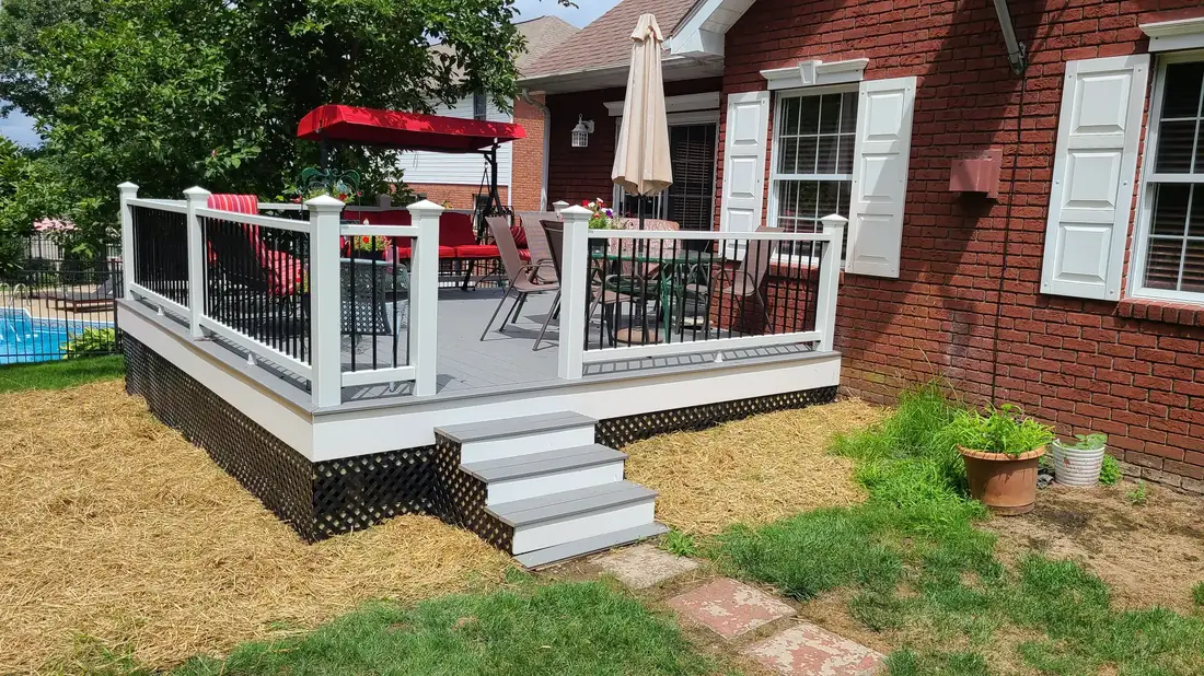 White-rail deck on a brick home — Oasis Custom Decks