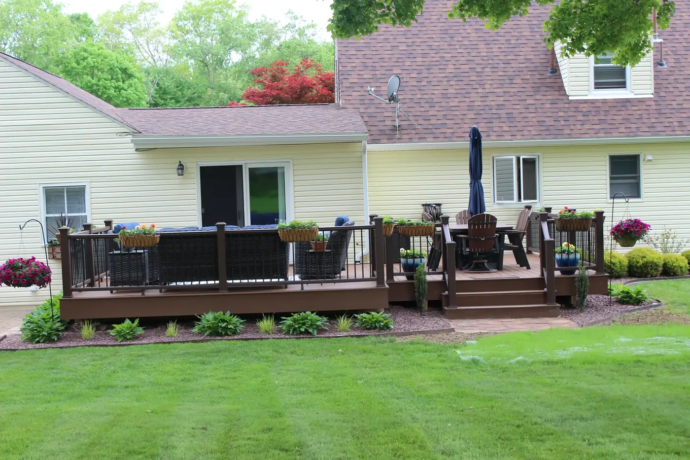 Composite deck with dining and umbrella — Oasis Custom Decks