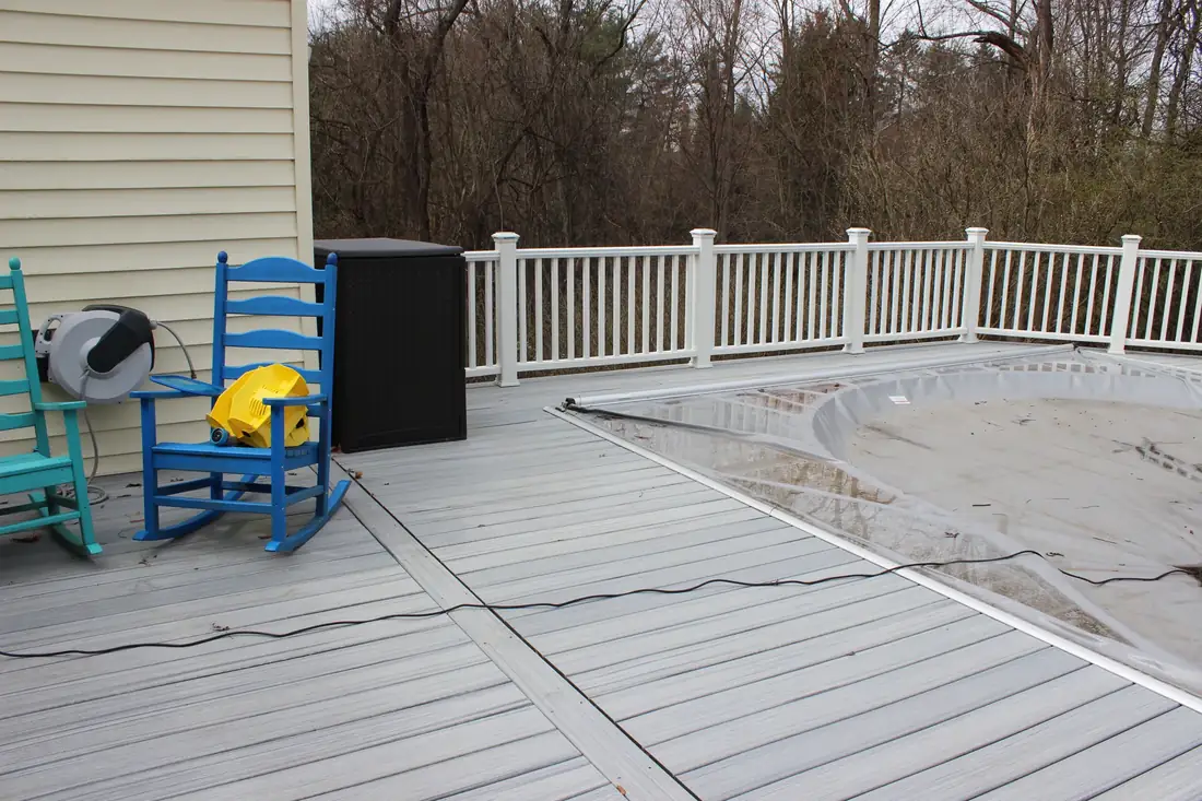 Poolside seating on gray composite — Oasis Custom Decks