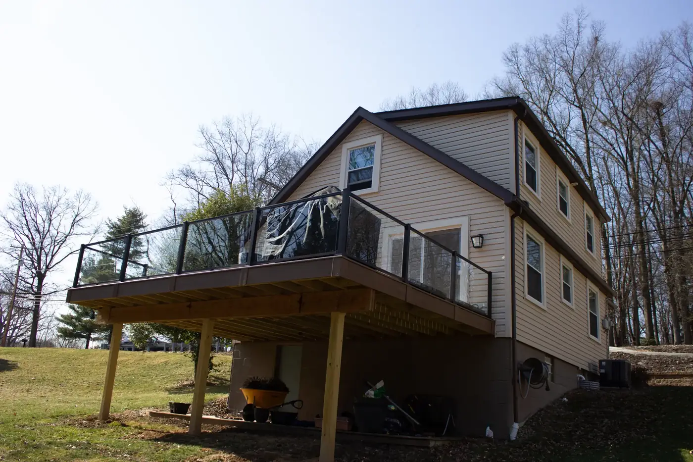 Elevated deck with glass-panel railing — Oasis Custom Decks