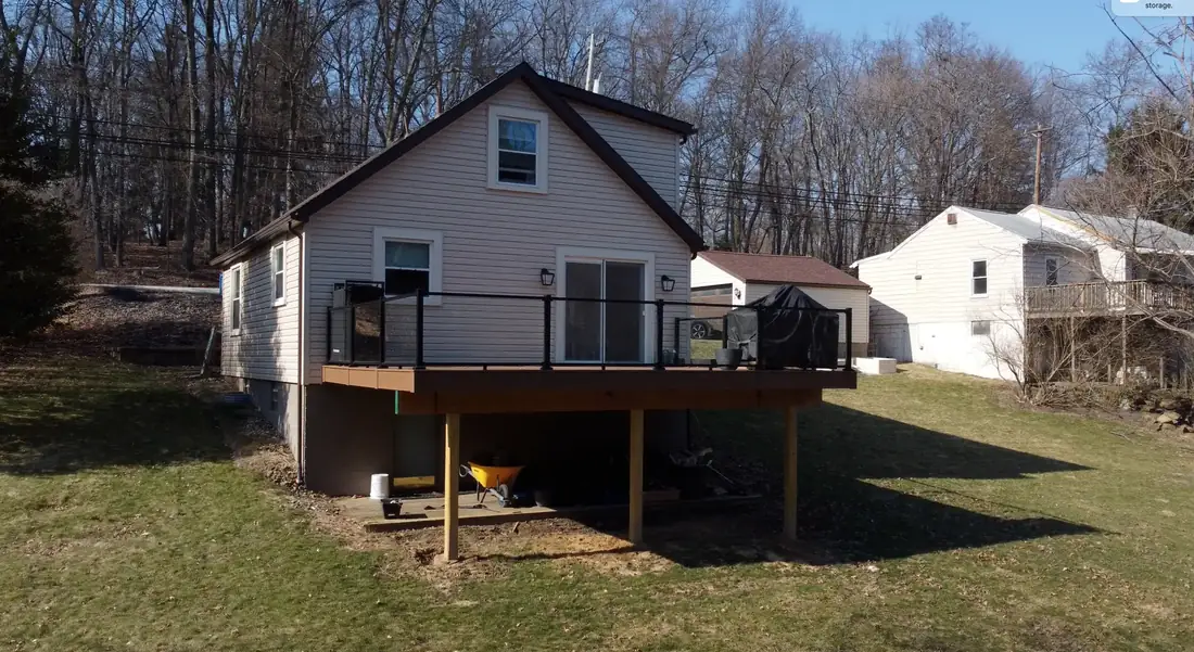 Dark composite deck with black aluminum rail — Oasis Custom Decks
