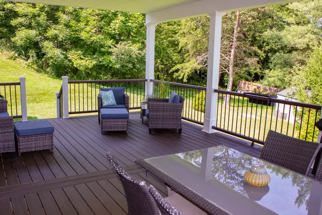 Dining and lounge on a shaded composite deck — Oasis Custom Decks