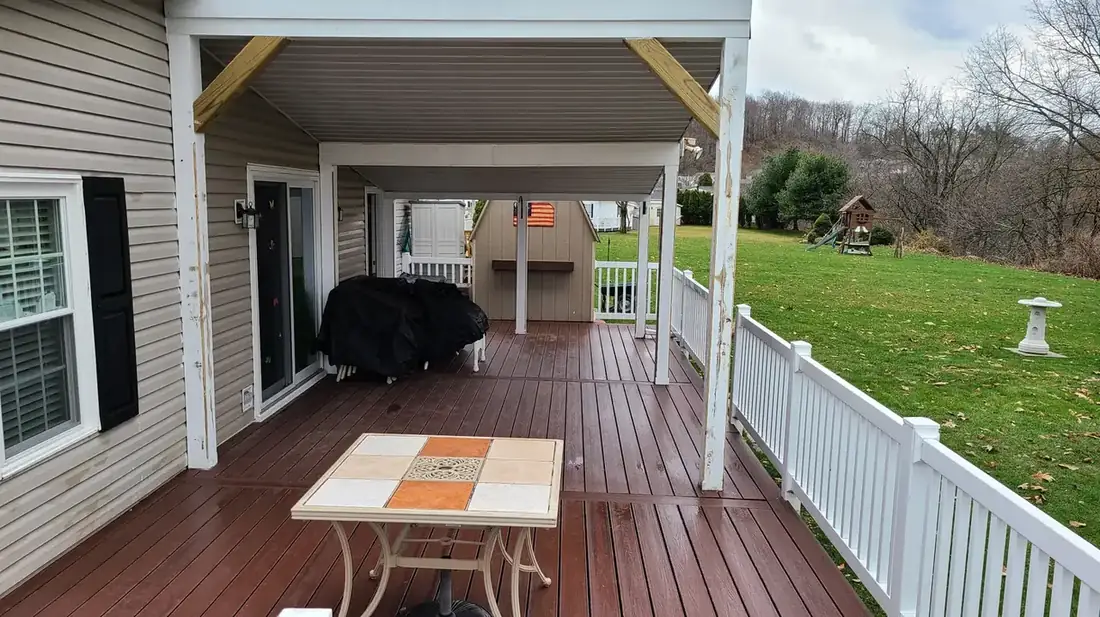 Covered deck with rustic red composite — Oasis Custom Decks