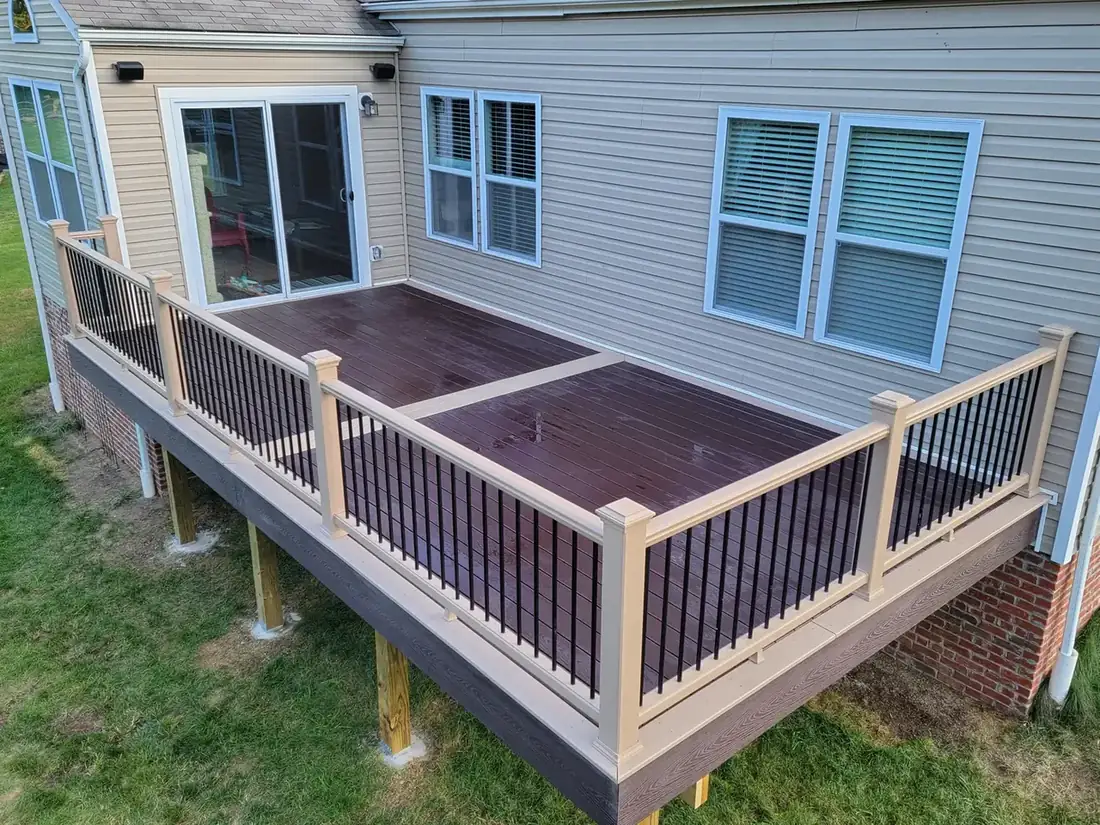 Dark composite deck with picture-frame border — Oasis Custom Decks