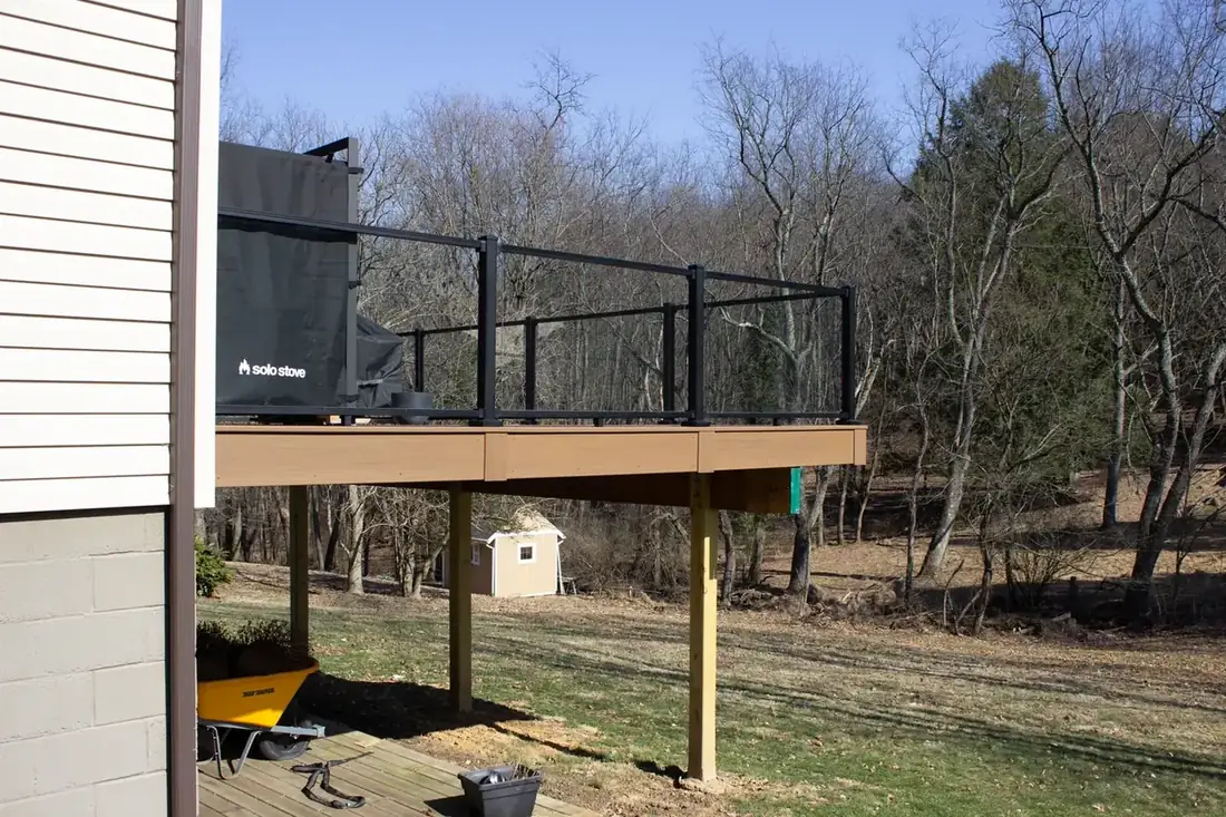 Steel-post glass railing, elevated deck — Oasis Custom Decks