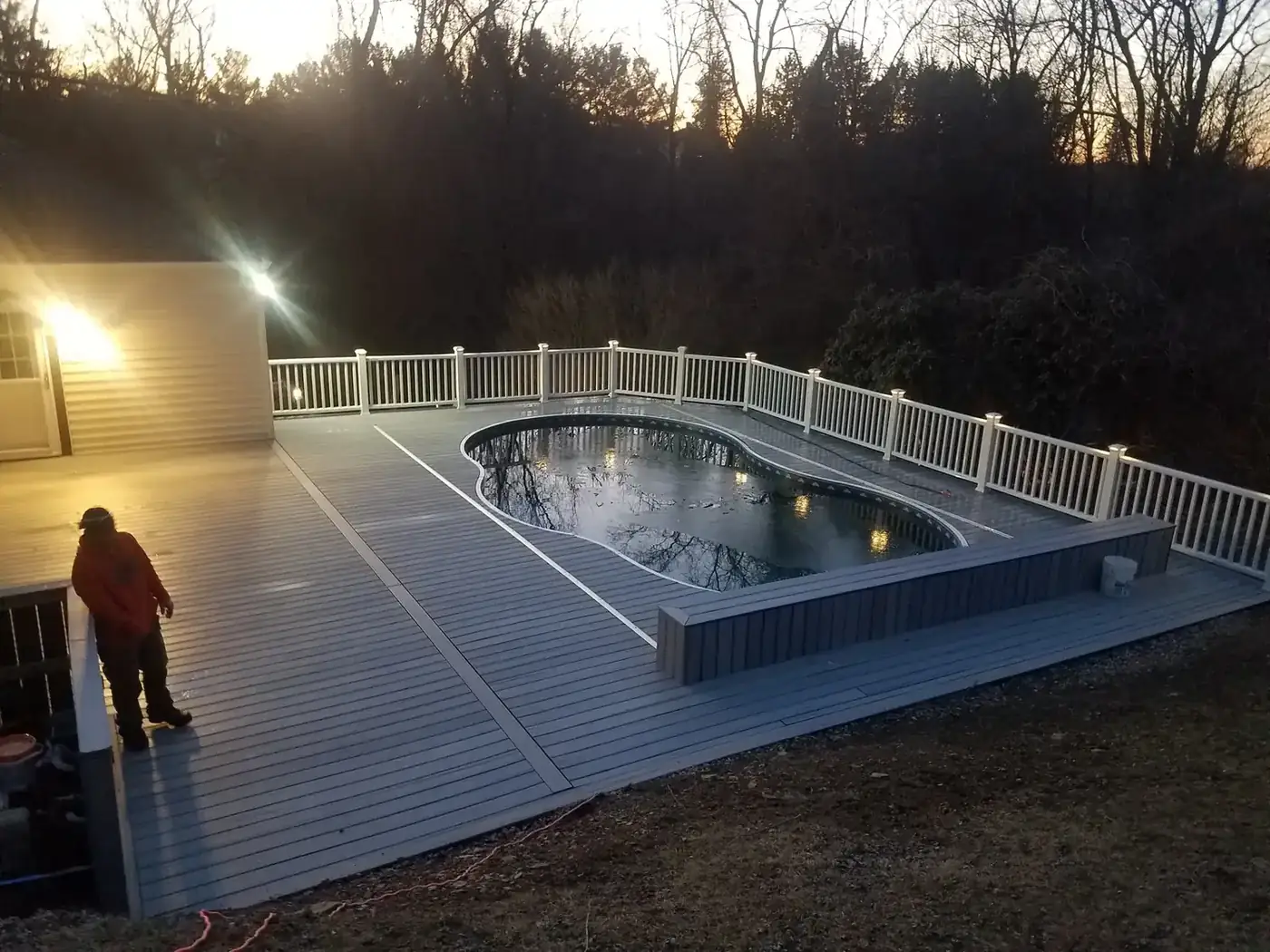 Pool surround deck at dusk — Oasis Custom Decks
